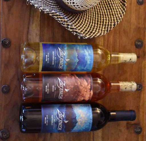 Zarpara wine bottles horizontal on wood with stray hat